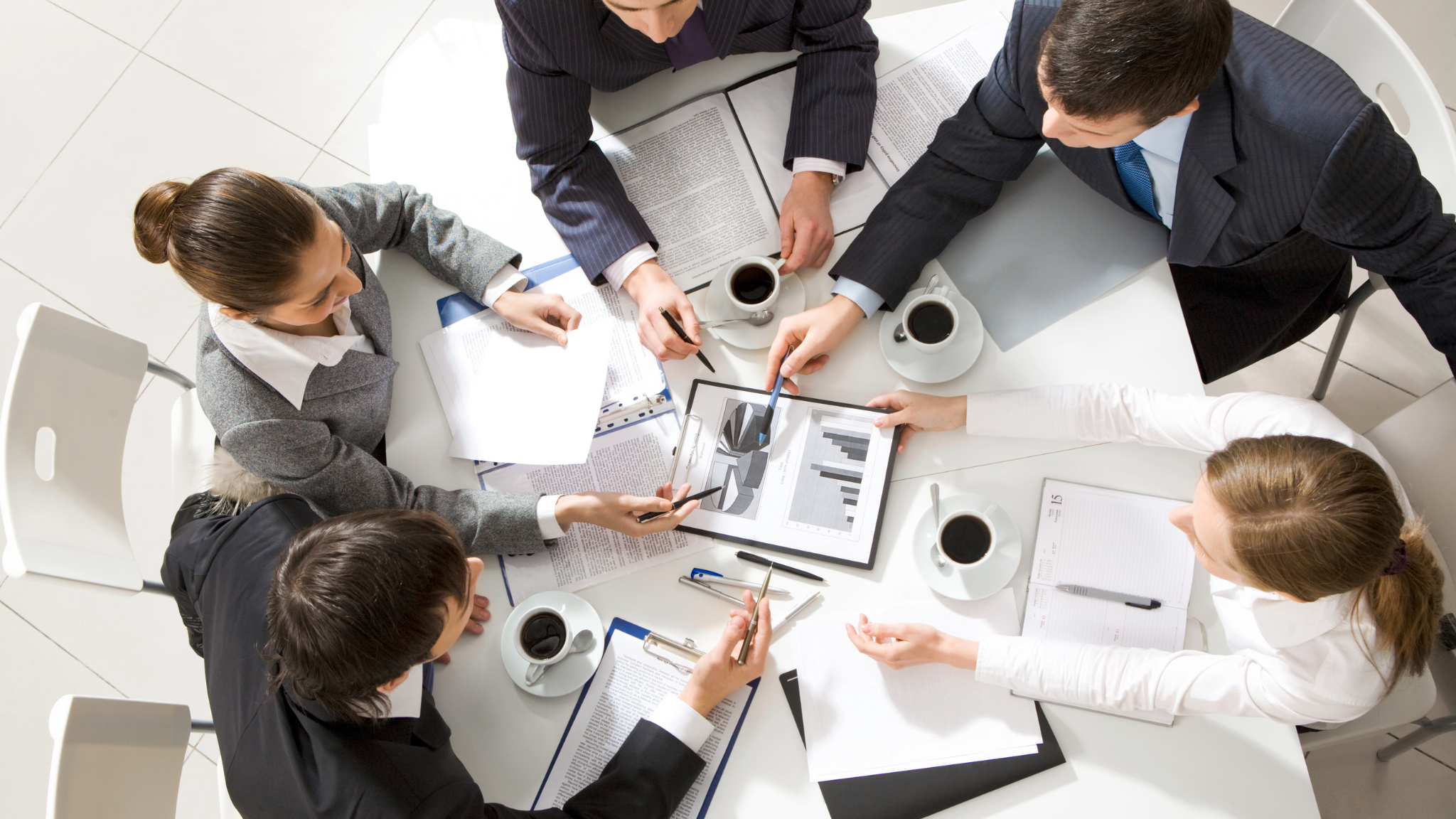 Business team analyzing reports related to airline group booking errors