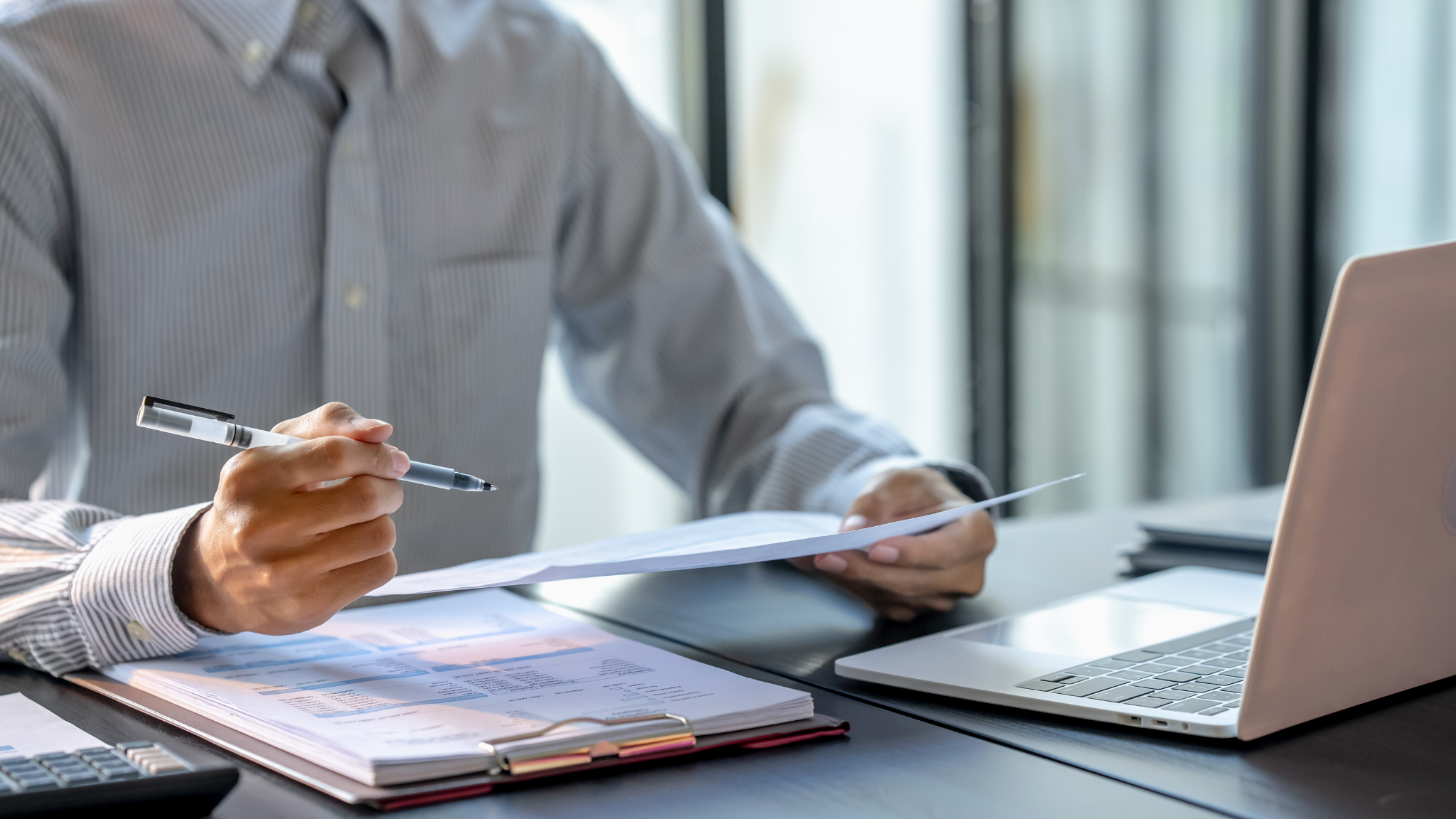 Airline group sales professional reviewing documents to prevent revenue leakage using GroupRM