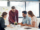 A gathering of individuals around a table, featuring a man and woman actively participating in the discussion about Top 5 Ways AI-Driven Dynamic Pricing Will Transform Group Sales in 2026