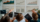 A group of people analyzing graphs displayed on a table during a meeting about 7 Benefits of Self-Service Group Portals for Airlines in 2026