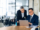 Airline professionals using technology to coordinate connected systems and improve API orchestration for group booking operations.