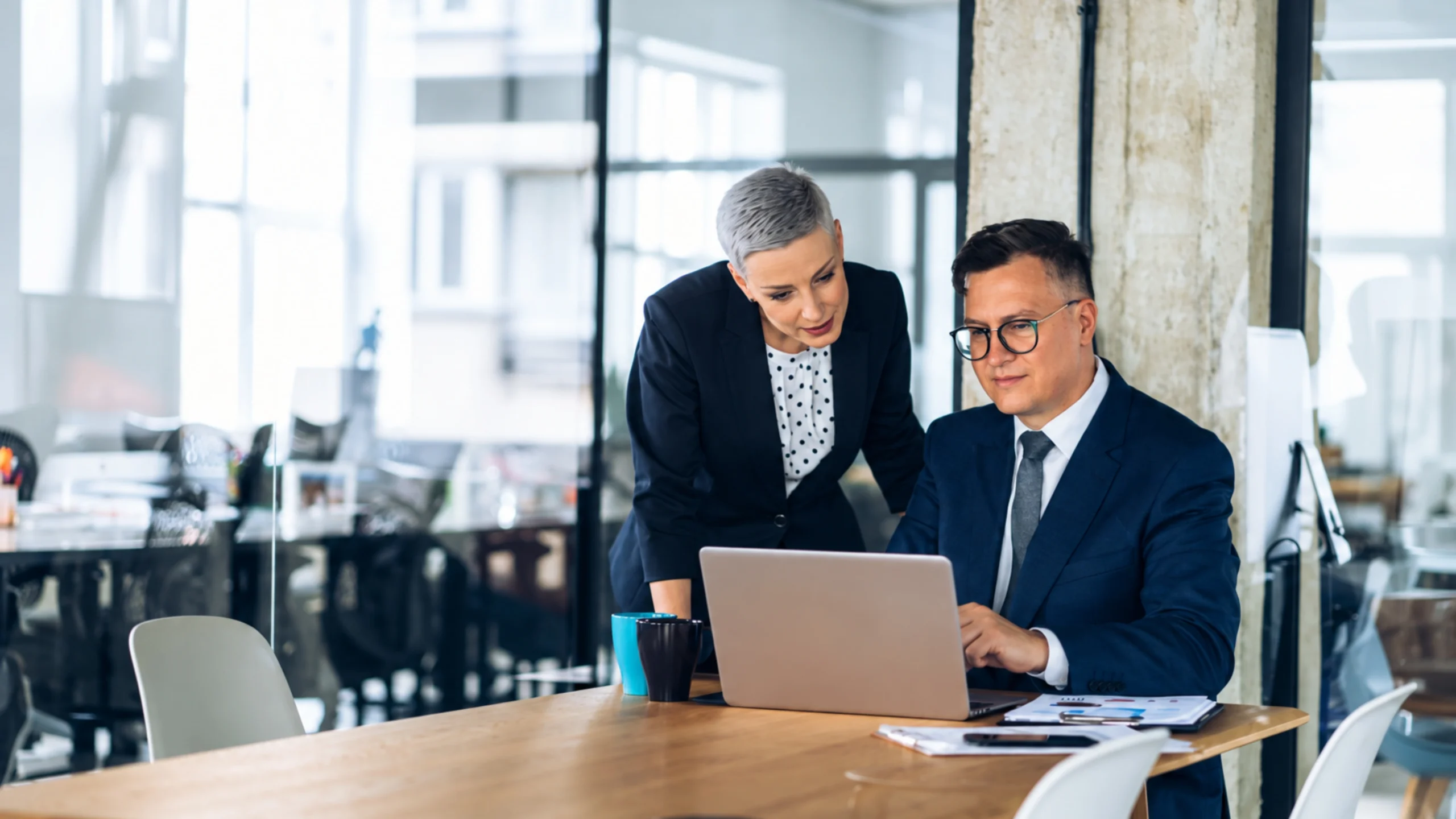 Airline professionals using technology to coordinate connected systems and improve API orchestration for group booking operations.